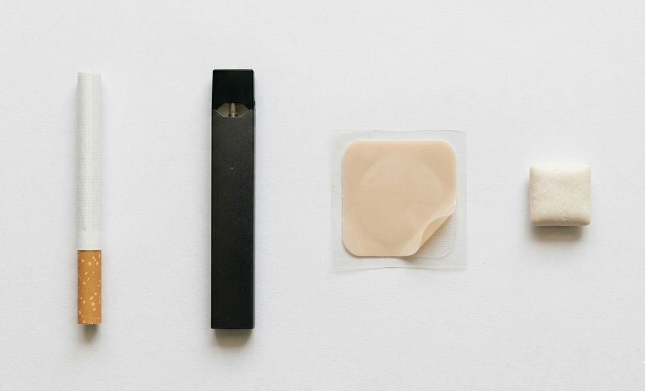 how long does nicotine stay in your system – cigarette, vape pen, nicotine patch and gum on a clean white surface